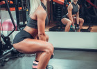 beautiful woman working out with a dumbbells in a gym